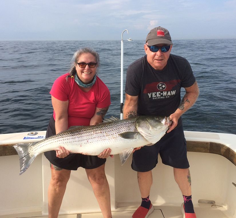 Wallace's hook some Stripers  on a Point Judith Fishing Charter